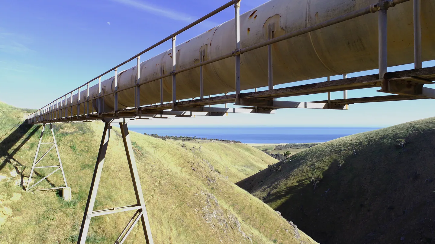 Pipeline bridge crossing a grassy valley