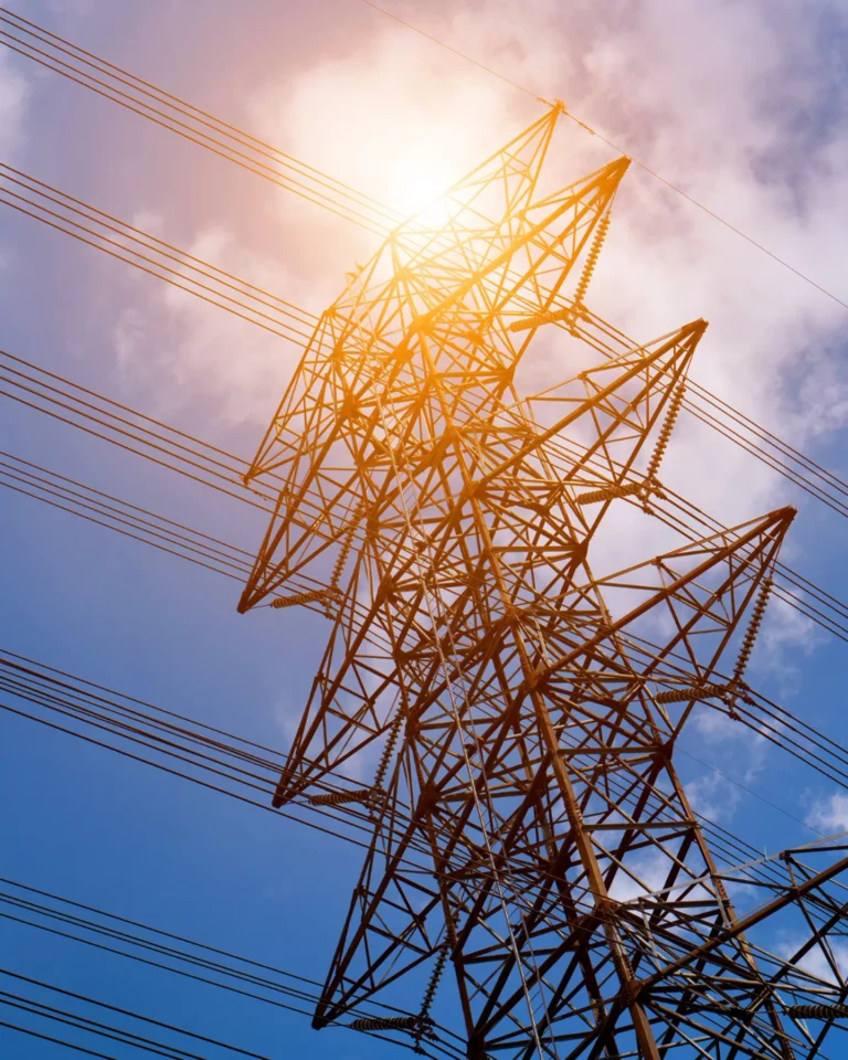 Electric power transmission tower under bright sunlight