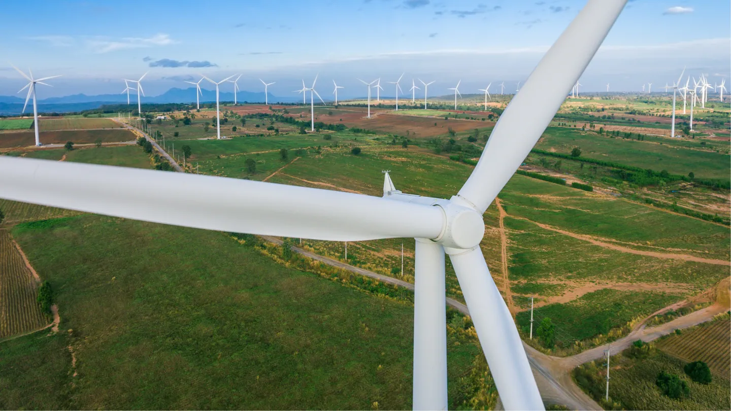 Wind turbines generating renewable energy in open fields